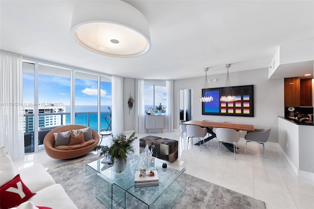 tiled living room with expansive windows and a water view