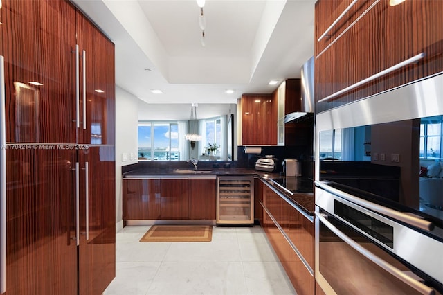 kitchen featuring sink, beverage cooler, light tile patterned floors, black electric cooktop, and double wall oven