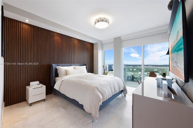 bedroom featuring floor to ceiling windows