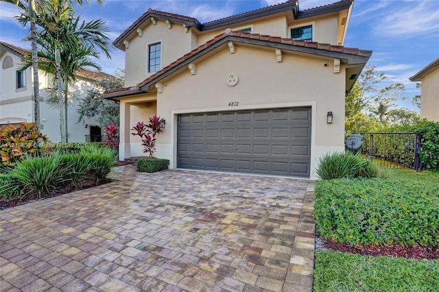 mediterranean / spanish home featuring a garage