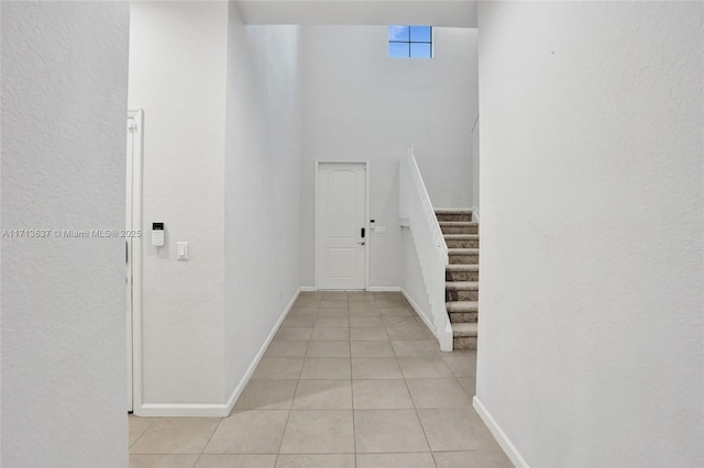 hall featuring light tile patterned flooring