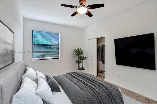 carpeted bedroom featuring a closet and ceiling fan