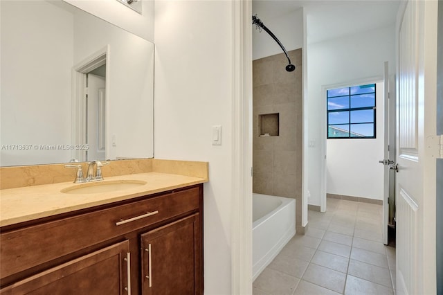 bathroom with tile patterned flooring, vanity, and tiled shower / bath combo