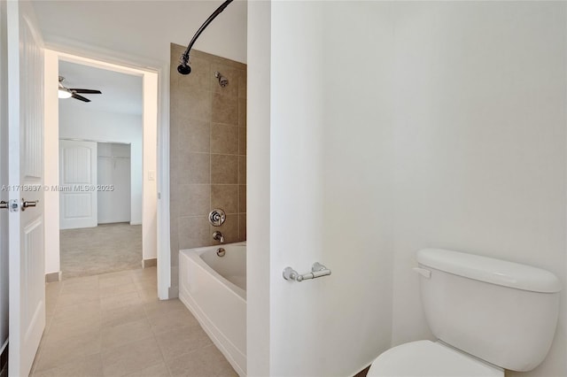 bathroom featuring ceiling fan, tiled shower / bath combo, and toilet