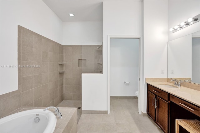 full bathroom featuring plus walk in shower, vanity, toilet, and tile patterned flooring