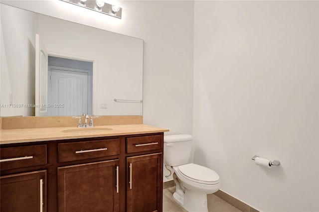 bathroom featuring tile patterned floors, vanity, and toilet