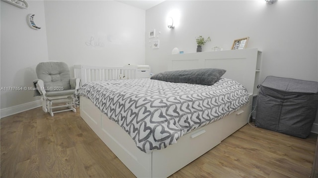 bedroom with hardwood / wood-style floors