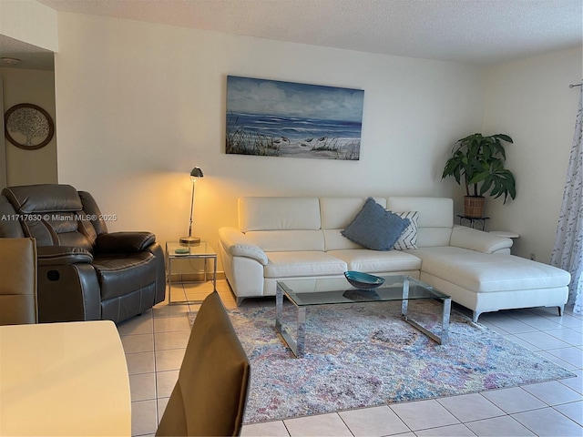 tiled living room featuring a textured ceiling