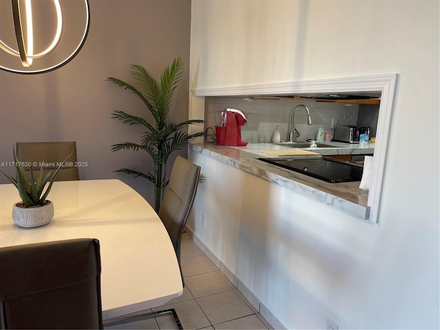 dining area featuring light tile patterned floors and sink