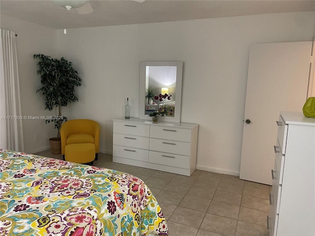 bedroom with ceiling fan and light tile patterned floors