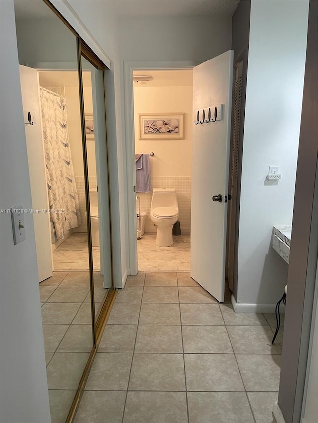 corridor featuring light tile patterned floors