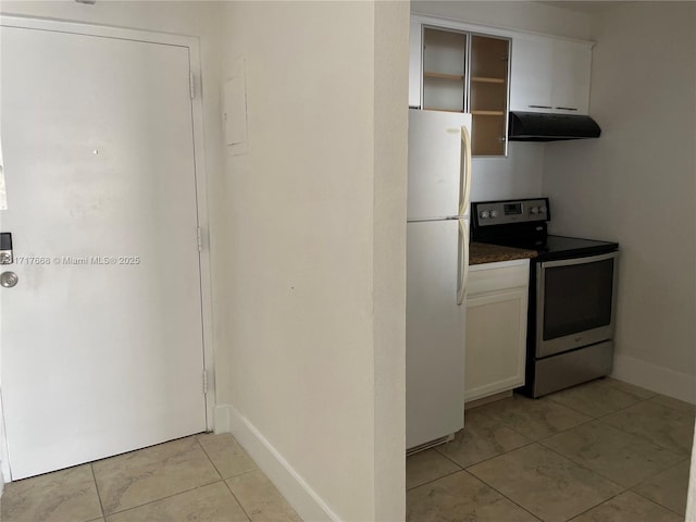 kitchen with white cabinetry, stainless steel electric range oven, white fridge, and light tile patterned floors