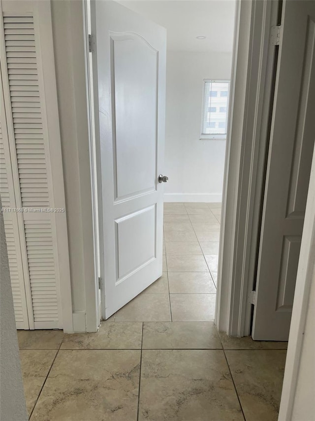 hallway featuring light tile patterned floors