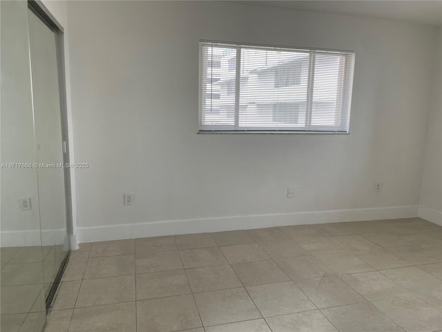 unfurnished room featuring light tile patterned floors