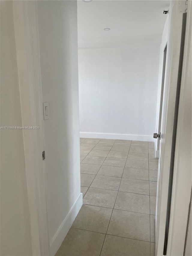 hall with light tile patterned flooring