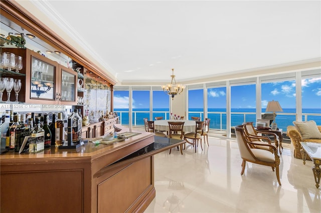 bar with a water view, ornamental molding, a notable chandelier, and a wall of windows