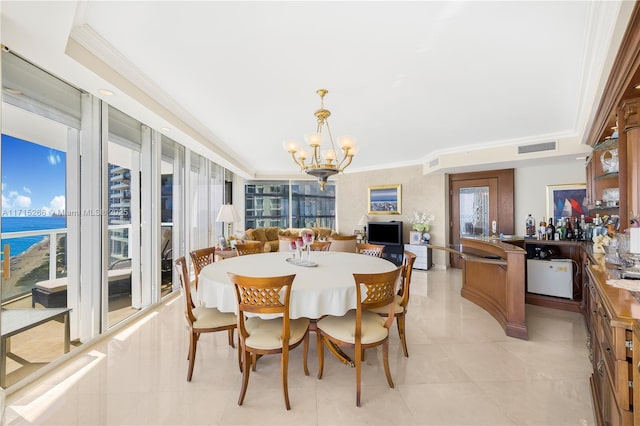 dining area featuring light tile patterned floors, an inviting chandelier, a tray ceiling, a water view, and ornamental molding