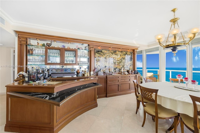 kitchen with kitchen peninsula, a water view, hanging light fixtures, and ornamental molding