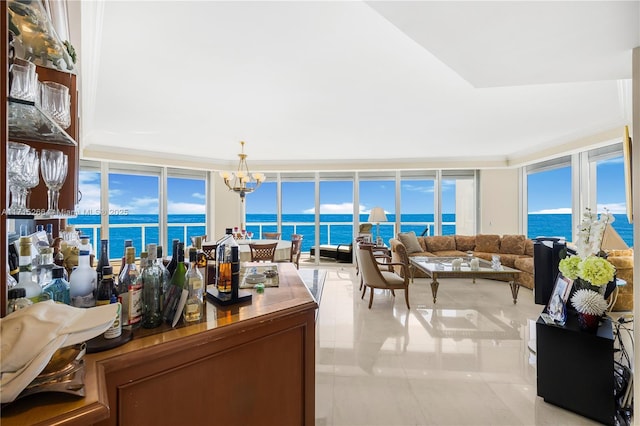 living room featuring expansive windows, a water view, a chandelier, and light tile patterned floors