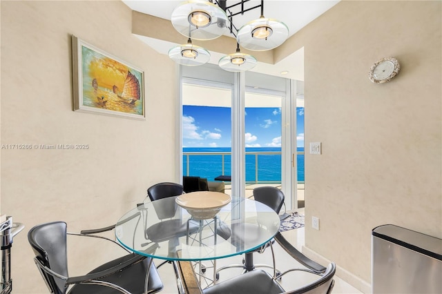 tiled dining area featuring a water view