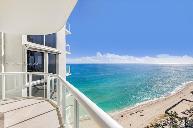 balcony with a view of the beach and a water view