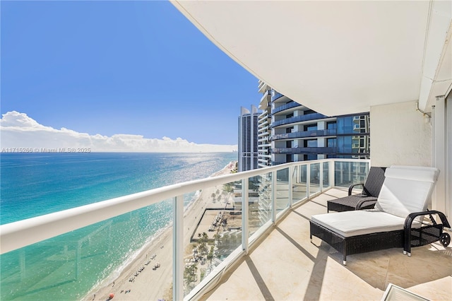 balcony with a view of the beach and a water view