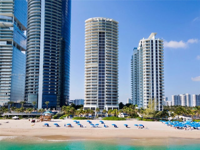 exterior space with a water view and a view of the beach