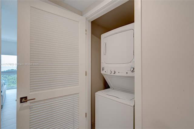 laundry room featuring stacked washer and clothes dryer