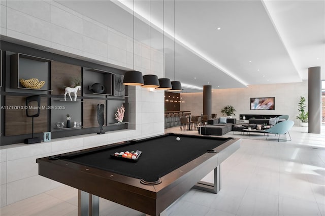 playroom with light tile patterned floors, tile walls, and pool table