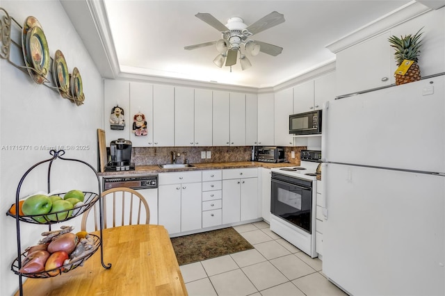 kitchen with white appliances, backsplash, white cabinets, sink, and light tile patterned floors