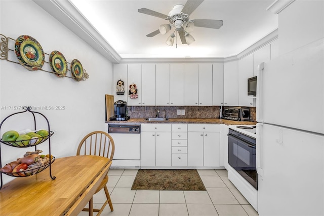 kitchen featuring white cabinetry, sink, white appliances, decorative backsplash, and light tile patterned flooring