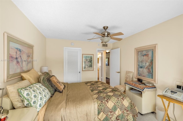 carpeted bedroom featuring a closet and ceiling fan