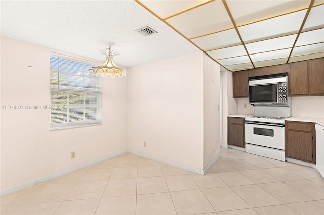 kitchen with light tile patterned floors and white appliances