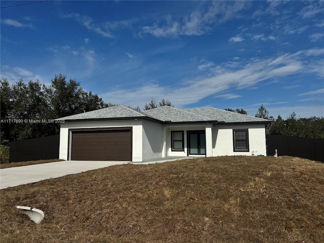 view of front of property with a front yard and a garage