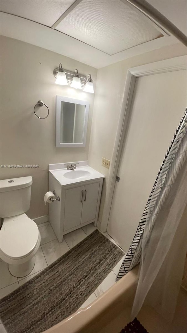 full bathroom with tile patterned flooring, vanity, toilet, and shower / bath combo with shower curtain