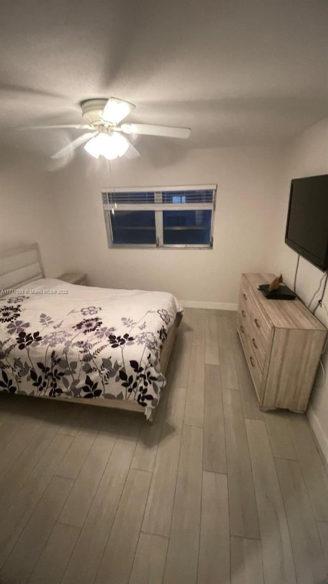 unfurnished bedroom with light wood-type flooring and ceiling fan