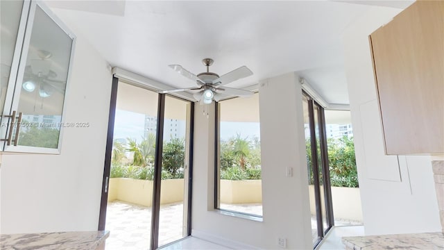 doorway to outside featuring ceiling fan