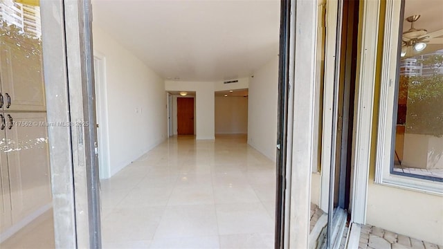 corridor with light tile patterned floors