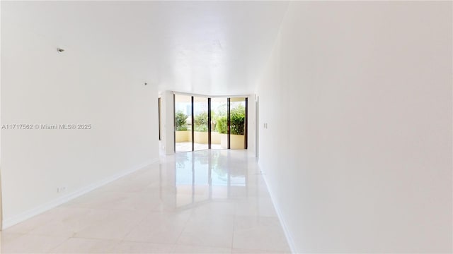 tiled spare room with floor to ceiling windows