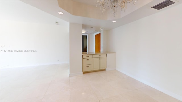 empty room with a notable chandelier and a towering ceiling