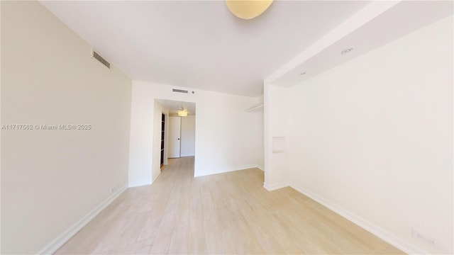 unfurnished room with light wood-type flooring