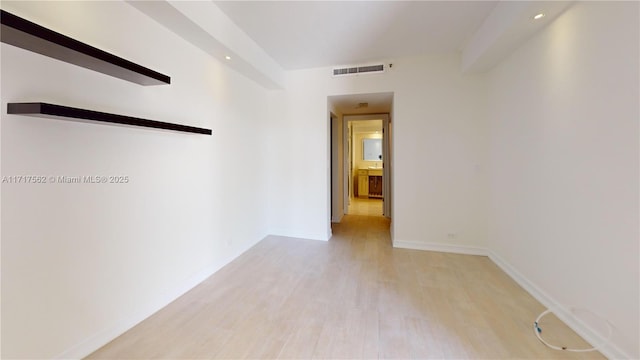 corridor with light hardwood / wood-style floors