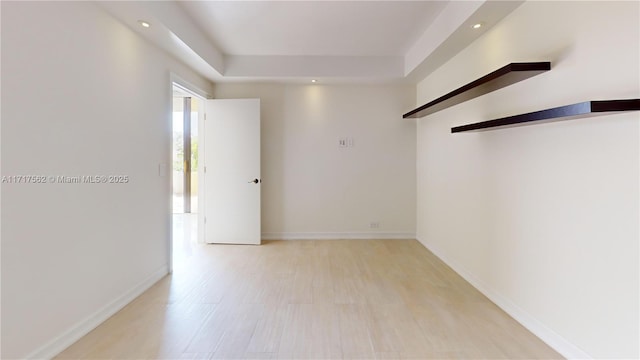 empty room with light hardwood / wood-style flooring