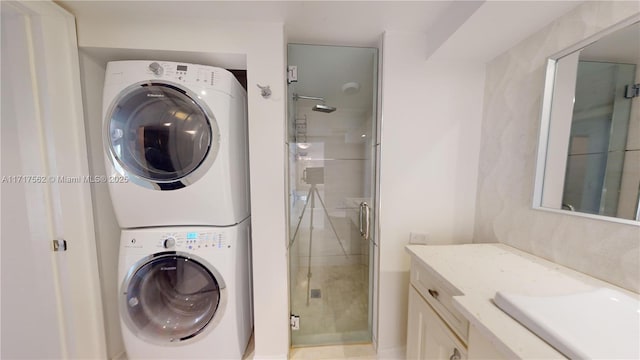 laundry room with sink and stacked washer / dryer