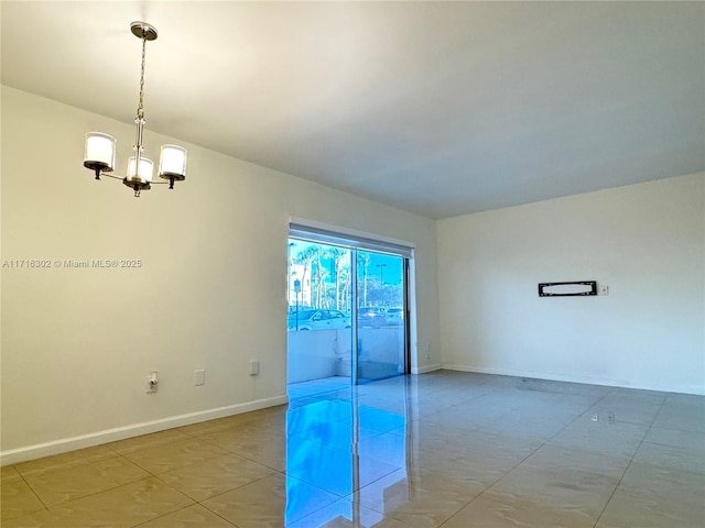 empty room with a notable chandelier