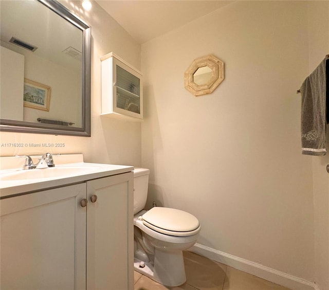 bathroom with vanity, tile patterned floors, and toilet