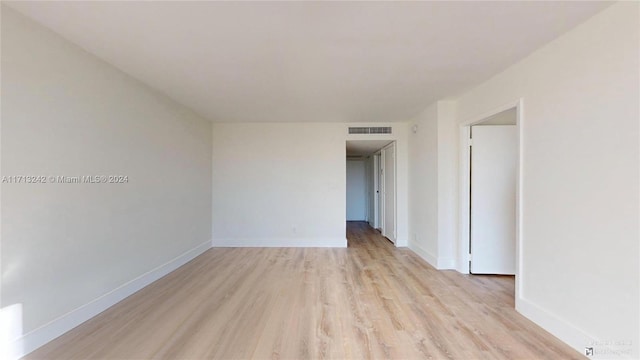 unfurnished room with light wood-type flooring