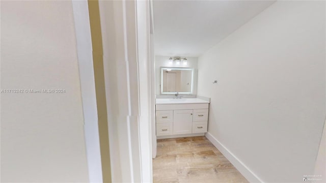 bathroom with hardwood / wood-style flooring and vanity