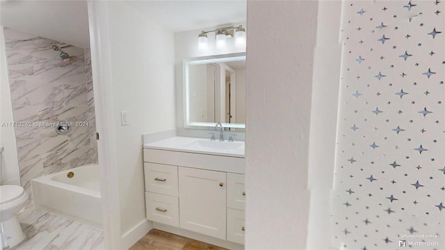 full bathroom with vanity, toilet, and tiled shower / bath combo