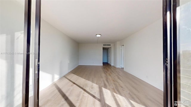 unfurnished room with light wood-type flooring